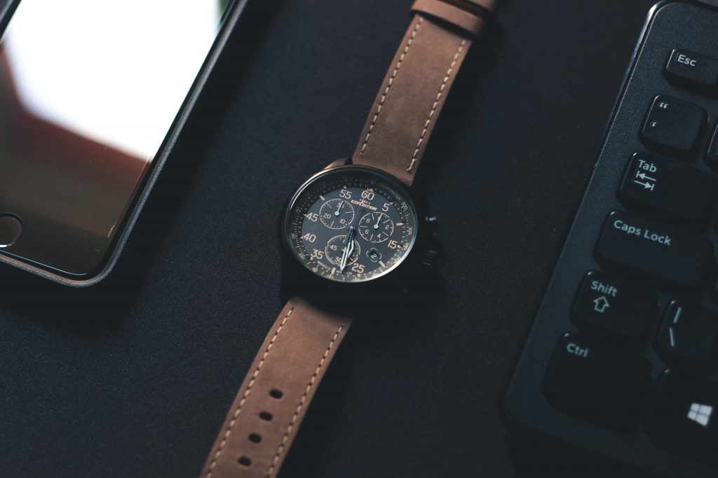 Timex military watch brand with black case and brown leather straps