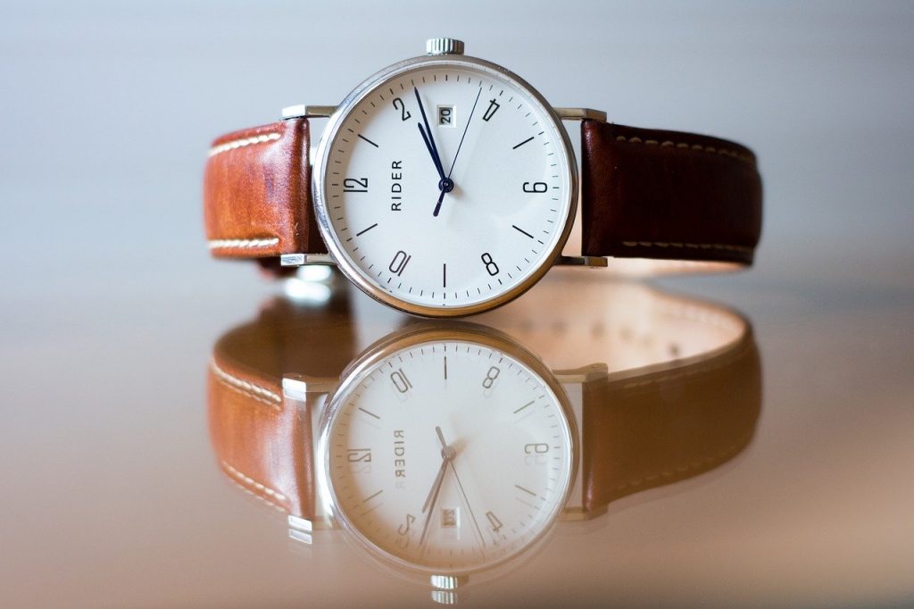 classic analog watch with white dial and brown straps