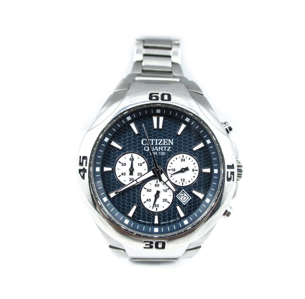 metal wristwatch with dark blue dial and three white sub-dials