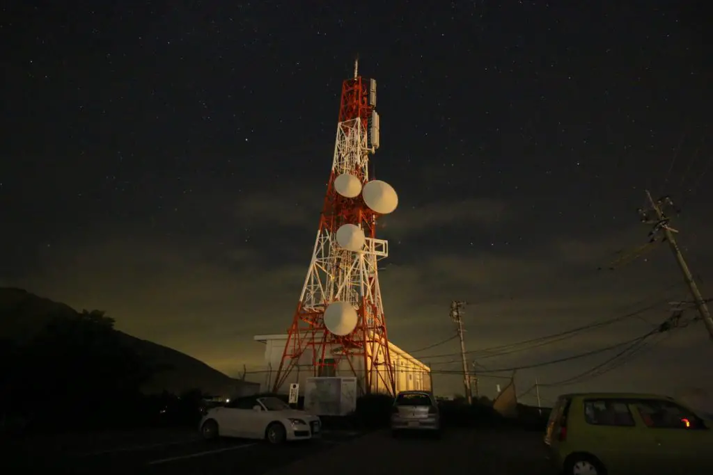 radio tower in the night providing adjustments to watches