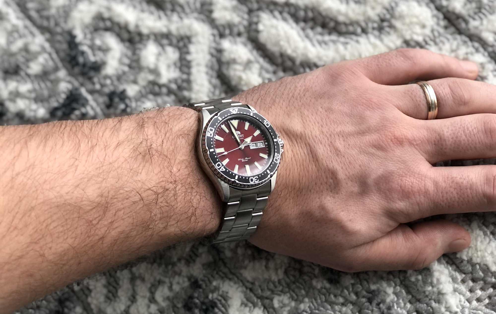 Orient diver with a burgundy red dial