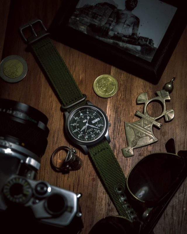 Green Seiko SNK flat on a table