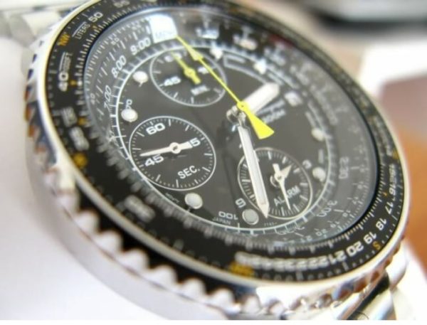 Watch with busy dial and slide rule bezel