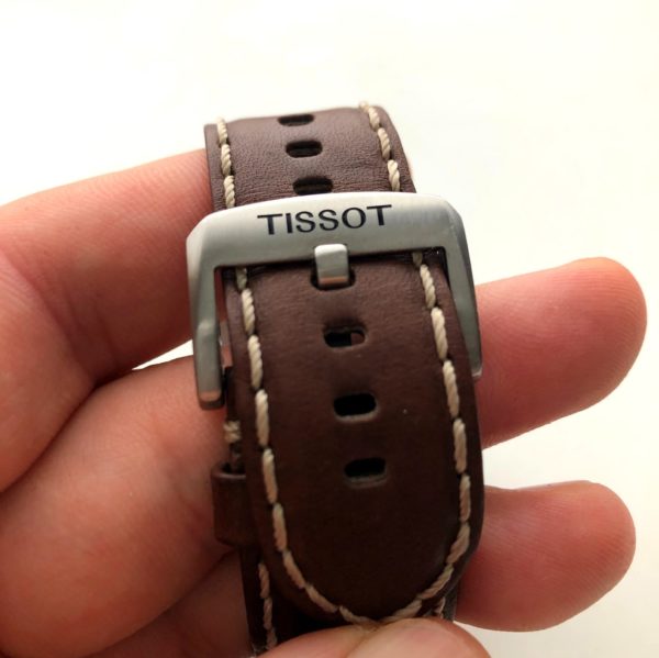 A simple tang buckle on a brown leather strap