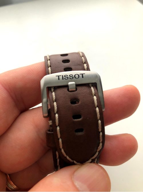 Brown leather band with a buckle closure